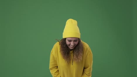 woman laughing over green background