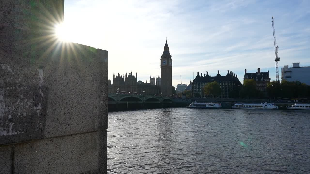 Seagulls flying over Thames River at sunset with Big Ben in background, London