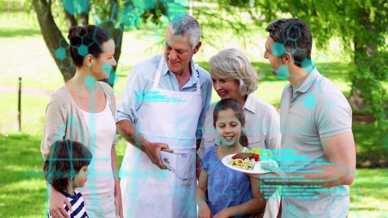 grandfather flipping burgers on barbecue grill, placing onto father's plate, uniting family in park