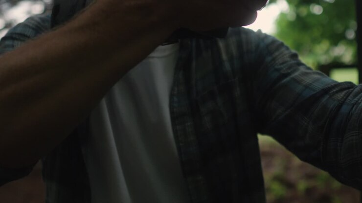 young caucasian male embracing shotgun for a shooting training in the forest