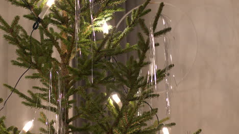 person decorating authentic christmas tree at home