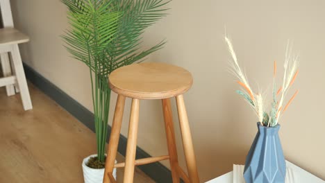 wooden stool with plant and vase in interior design