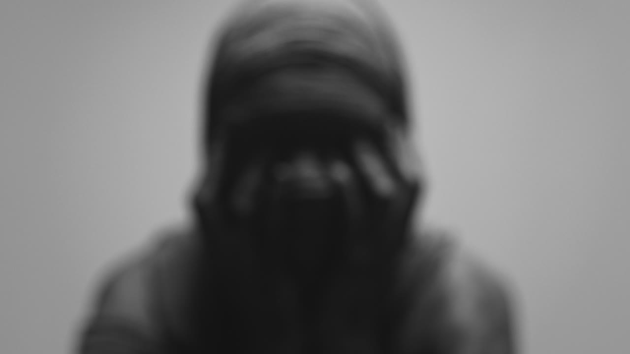 A mummified woman against the bright background in keeps her hands on her face the powerful pose full of despair