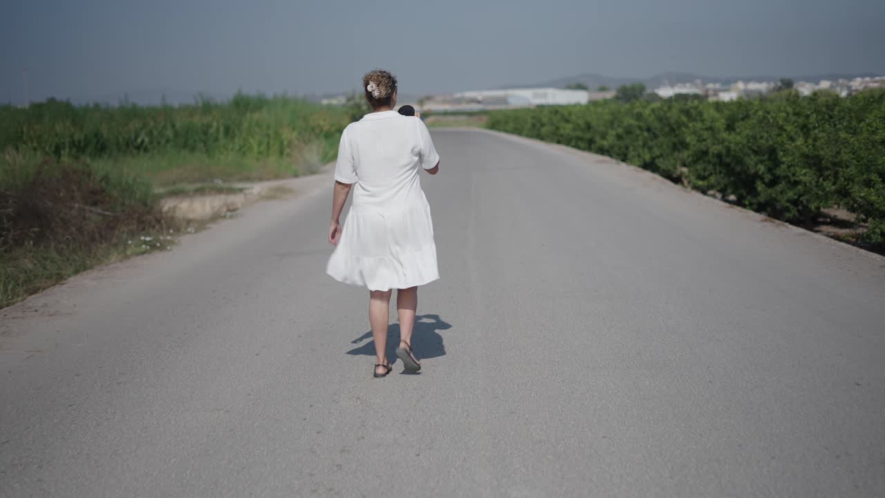 Woman Walking on a Country Road