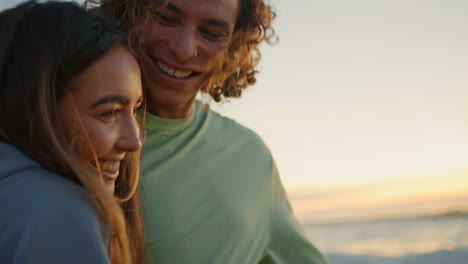 couple smiling at sunset on the beach