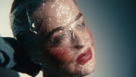 woman with plastic wrap mask