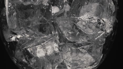 ice cubes moving empty glass closeup. refreshing cocktails making concept