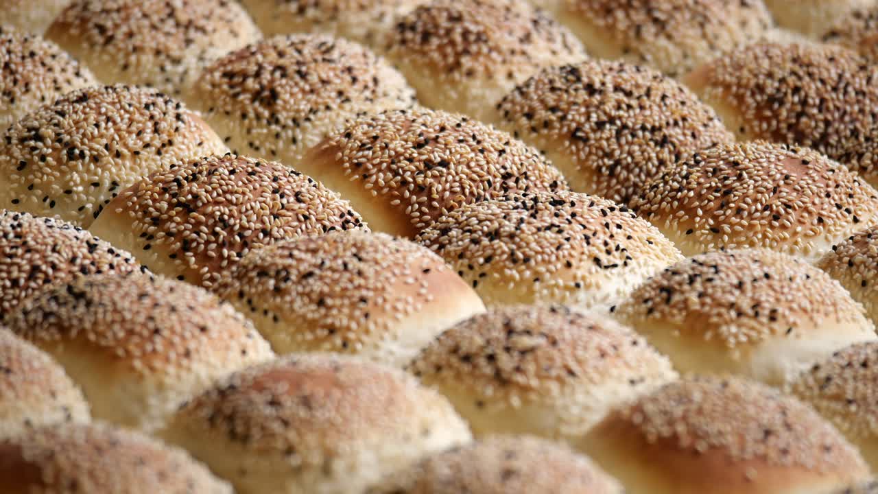 Tray of baked sesame seed buns