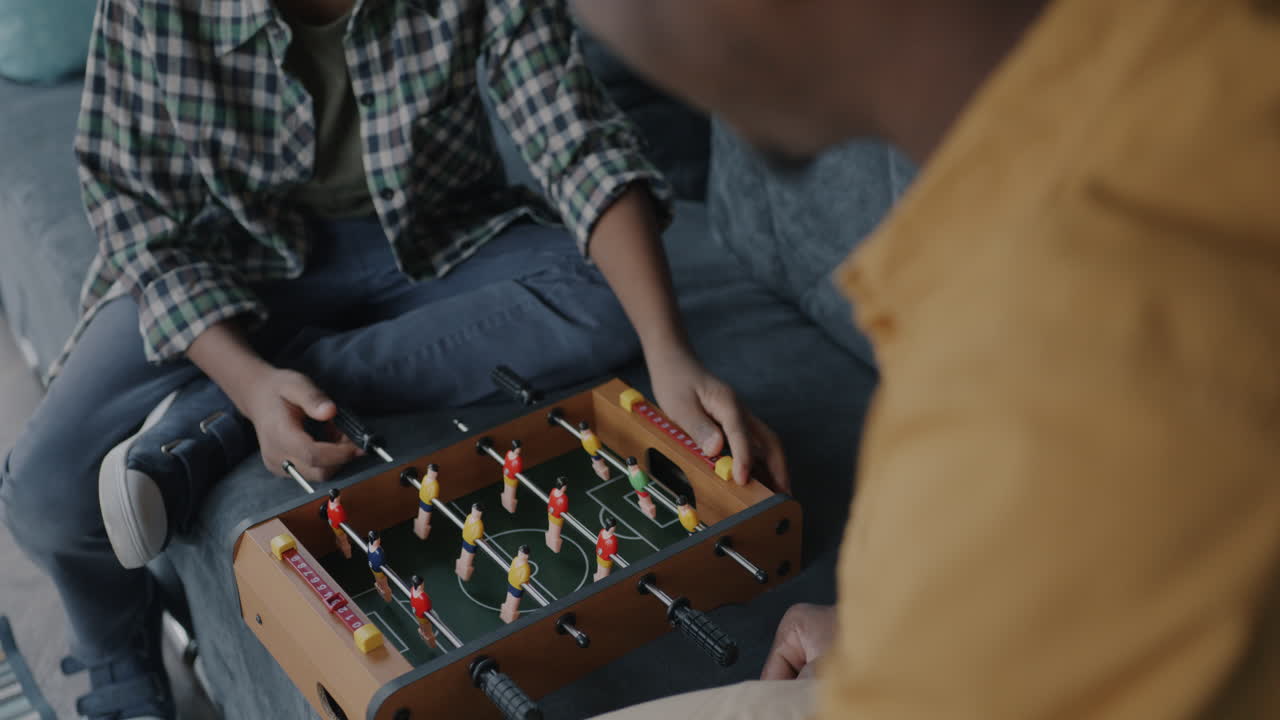 Father and Son Playing Foosball