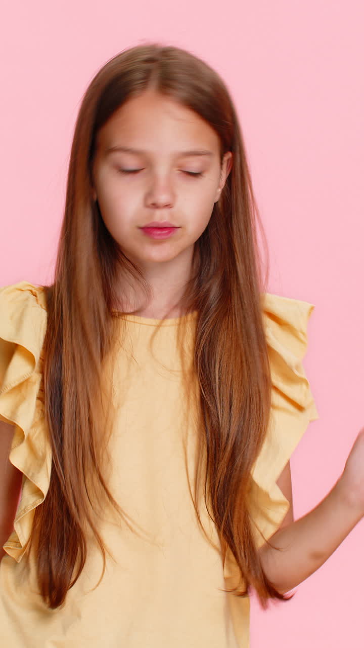 Child girl kid dancing with excitement showing rockandroll gesture with cool confident expression