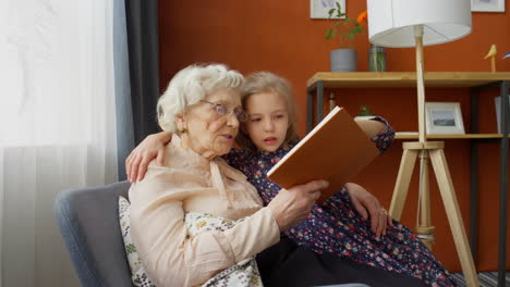 Grandma Reading Book with Granddaughter at Home