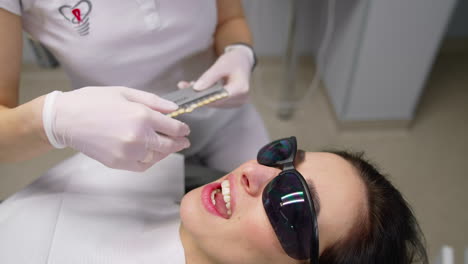 choosing the teeth for patient. dental doctor stomatologist.