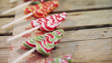 christmas tree lollipops on wooden table 4k