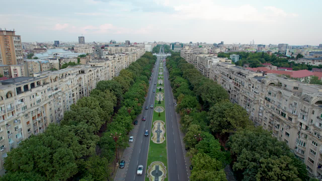 vista aérea del bulevar unirii, cerca de la plaza unirii en bucarest, rumania rodeada de altos edificios de apartamentos, vegetación exuberante y hermosas fuentes de agua, centro de la ciudad, tráfico, movimiento hacia atrás