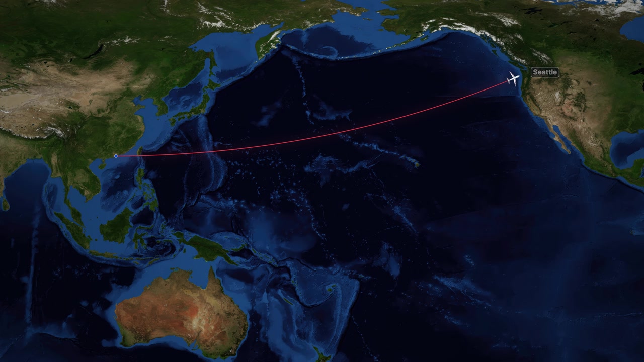 A red line tracks an airplane flying from Hong Kong to Seattle across the Pacific