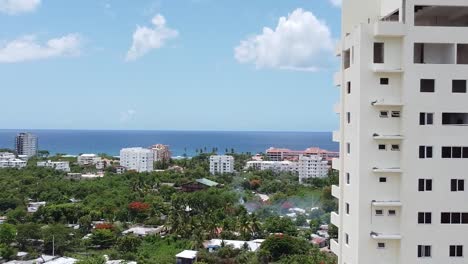 Juan-dolio,-Dominican-Republic---06-agosto-2021---aerial-shot-capturing-building-under-construction,-360-shot-with-beautiful-tourist-background-of-hotels-and-beaches