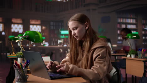 vertical video young adult studying in the university library to obtain her diploma