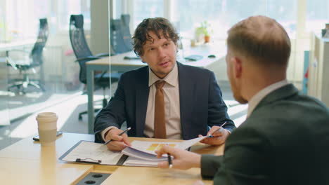businessman discussing report with colleague