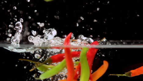 chili peppers falling in water