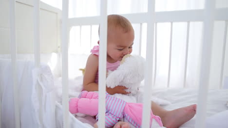 mother giving a cuddly toy to her baby