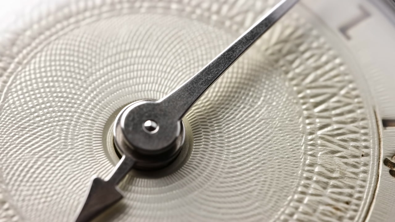 Close-up of a Watch Second Hand Ticking on a Detailed Dial