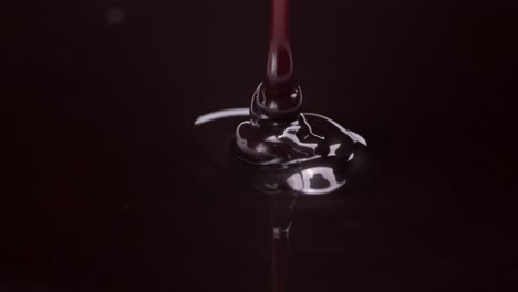 chocolate pouring in a smooth, rich flow, detailed spiral dispersing into darkness, slow motion macro