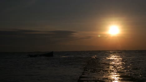 4k timelapse sunset on the pier and fishing boat