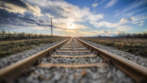 pov shot of emtpy railroad tracks in a desert sunny landscape