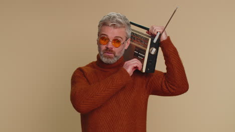 man using retro tape record player to listen music, disco dancing of favorite track, having fun