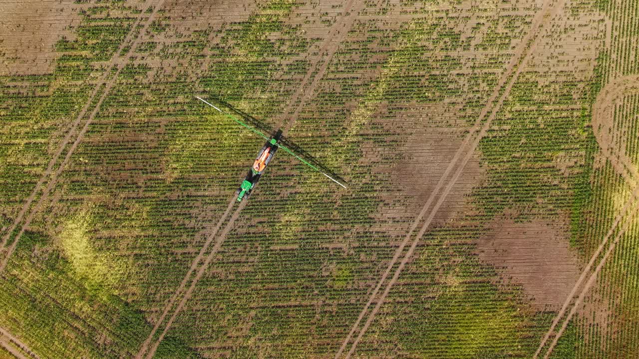 Overhead Aerial view of a tractor spraying a dry and parched agricultural field