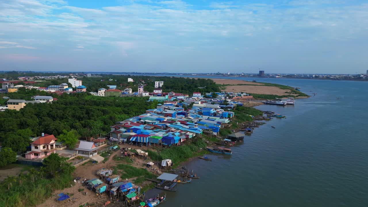 fishing village with colorful shacks along the Mekong river in Cambodia, a developing country in Southeast Asia. Great aerial view flight overflight flyover drone