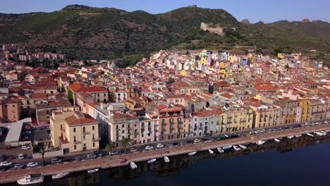 bosa,sardinia, italy - drone aerial shot of the colourful town of bosa in sardinia.bank turn right over the river temo with awesome green landscape