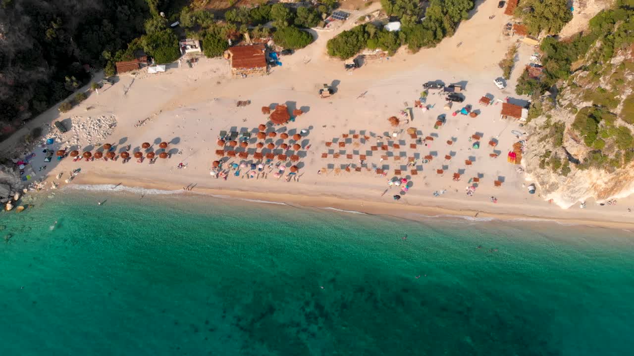 Slow cinematic drone tilt up over Gjipe beach and Canyon in Albania at sunset