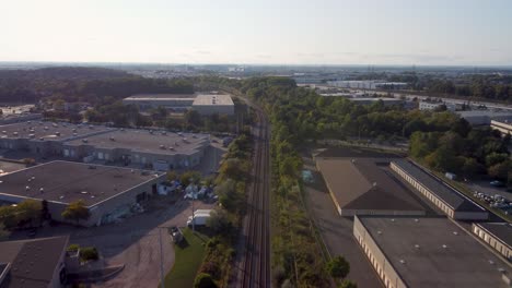 push in drone view on train tracks in an industrial area