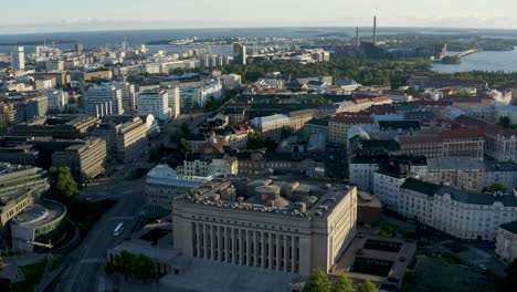Slow-aerial-reverse-shot-above-Parliament-Building-in-Helsinki,-Finland