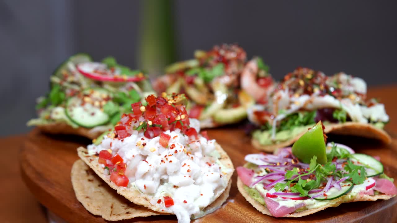 Mexican tostadas seafood shrimps spinning putting dressing on top