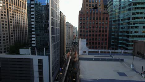 Urban-Scene-Chicago-L-Traveling-Past-Highrise-Buildings-In-Downtown-City-Center