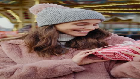 handheld video of woman opening christmas gift