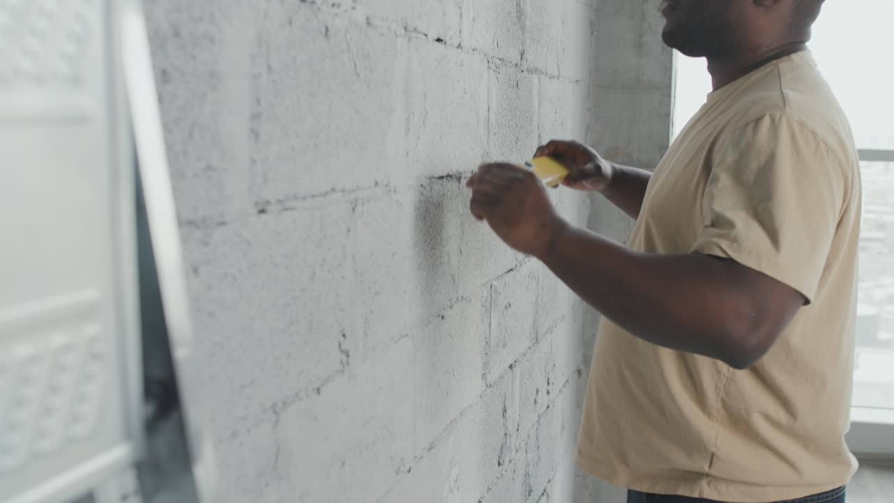 Man working on wall repair