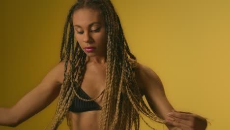 Black-woman-dancing-on-yellow-wall