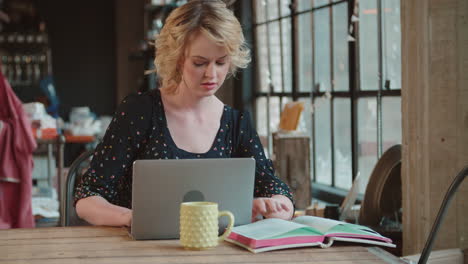 female fashion designer using laptop in studio shot on r3d