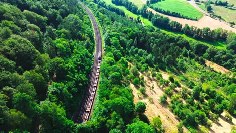 aerial drone cargo train along forest 4k