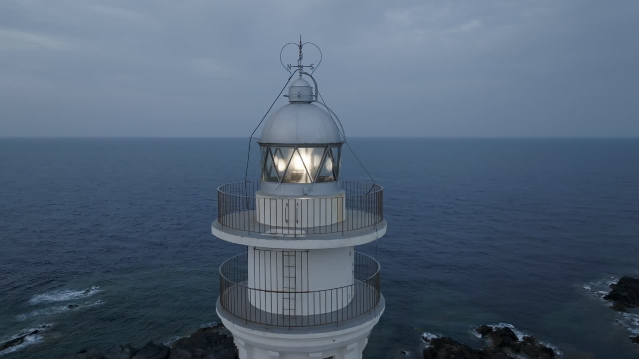 A close-up view of the Fav&agrave;ritx Lighthouse watching over the sea
