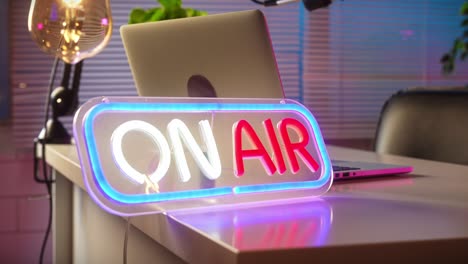 on air neon sign in a broadcast or podcast studio
