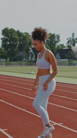 woman stretching on running track