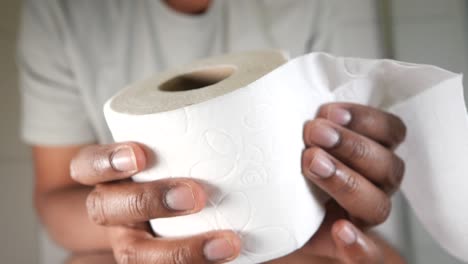 person holding toilet paper roll