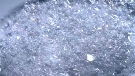 transparent foam bubbles movement and bursting in white bowl