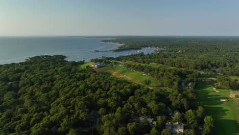 drone shot of lush forests surrounding a cape cod golf course