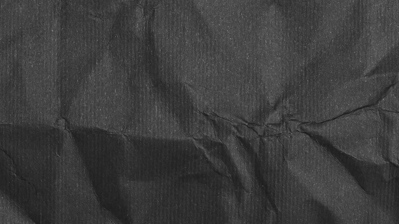 Crumpled paper craft sheet seamless texture dark black and white copy space, motion graphic