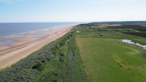 video from above captures the splendor of the saltwater marshes along the lincolnshire coast, showcasing seabirds soaring and perching on the lagoons and inland lakes